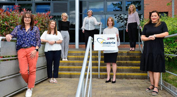 Careers team pictured on steps leading to Ballynahinch campus with board with matrix logo